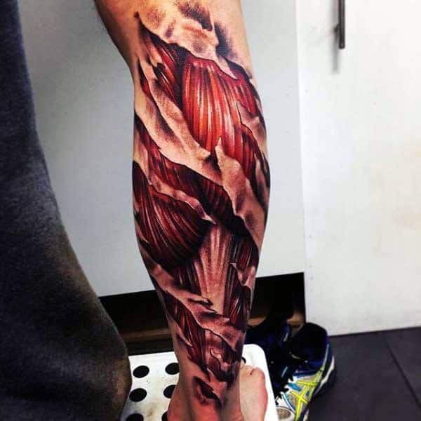 Realistic anatomical leg tattoo showing exposed muscle fibers in red tones, wrapping around the calf to mimic a peeled-skin effect.