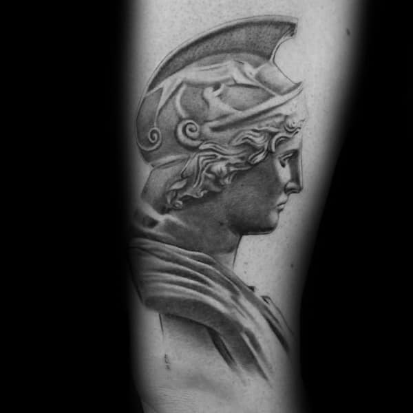 Realistic Athena profile tattoo with sculpted features and helmet, inspired by classical statues in soft black and grey shading
