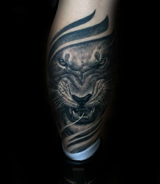 Guy With Back Of Leg Agressive Lion Tattoo