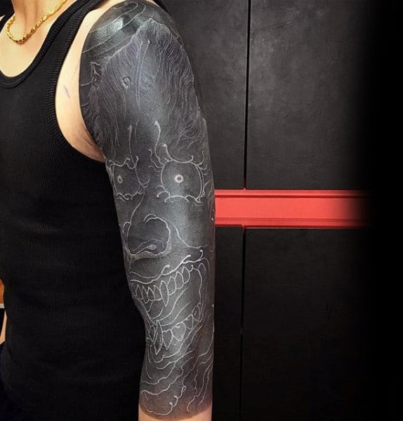 Guy With Black And White Evil Man Tattoo On Full Sleeves