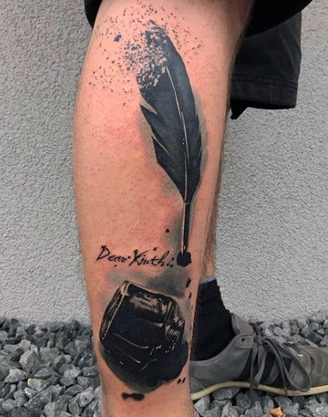 Guy With Black Feather Tattoo On Legs