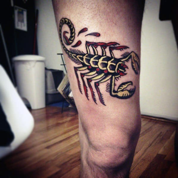 Guy With Black Red And Yellow Traditional Scorpion On Thigh Of Leg