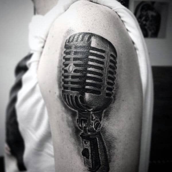 Guy With Black Shaded Microphone Tattoo On Arms