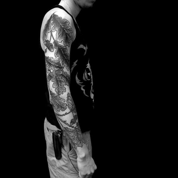 Guy With Black Shaded Oak Tree Leaf Tattoos Full Sleeves