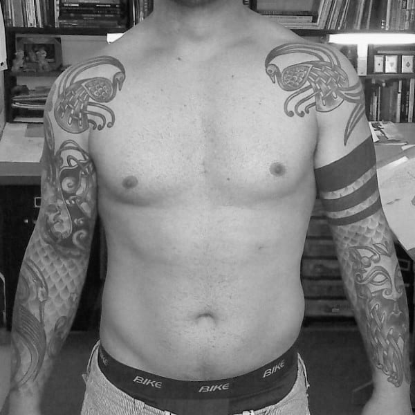 Guy With Celtic Themed Half Sleeve Tattoos On Both Arms