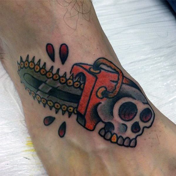 Colorful cartoon-style tattoo of a red chainsaw with a skull base, blood drops, and bold black outlines on the top of the foot.