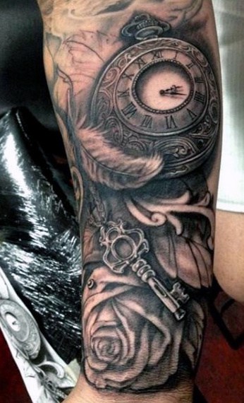 Guy With Clock And Feather Tattoo On Arms