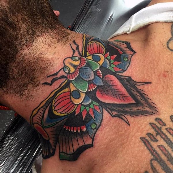 Bold and colorful throat tattoo of a stylized moth with intricate geometric patterns, vibrant hues, and striking wing details