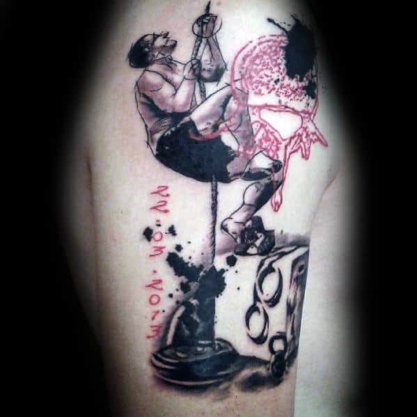 Artistic CrossFit tattoo featuring an athlete climbing a rope, with bold black ink and red splashes, symbolizing strength, endurance, and determination.