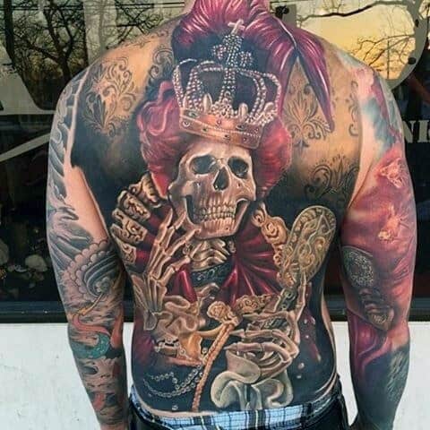 Guy With Crowned Skeleton And Red Feathers Tattoo Full Back