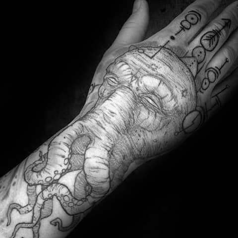 Guy With Cthulhu Hand And Wrist Tattoos