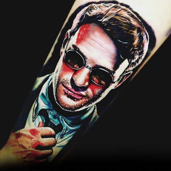 Vivid portrait tattoo of Matt Murdock with red bruises, tinted glasses, and detailed highlights capturing his dual identity.