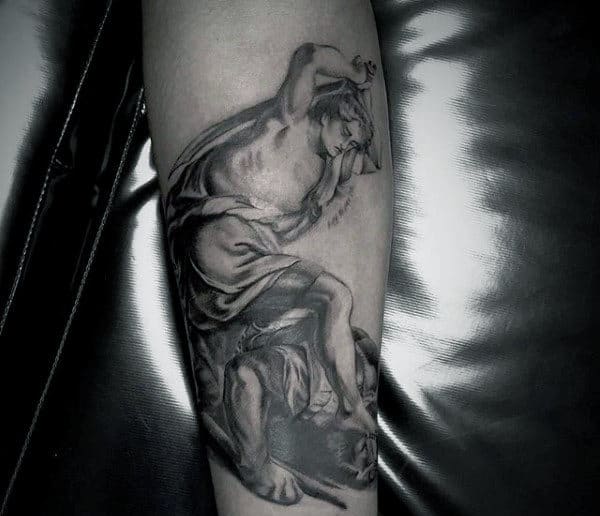 Guy With David And Goliath Forearm Tattoo Design