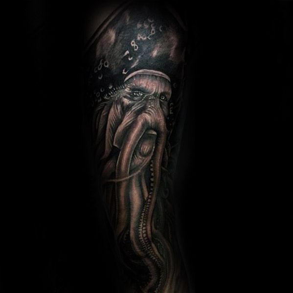 Tattoo of Davy Jones, a mythical sea creature, on a dark background