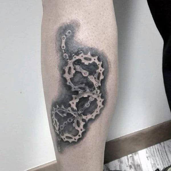 Guy With Elaborate Bicycle Gear Tattoo On Legs