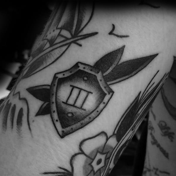 Guy With Filler Sheild Tattoo Design