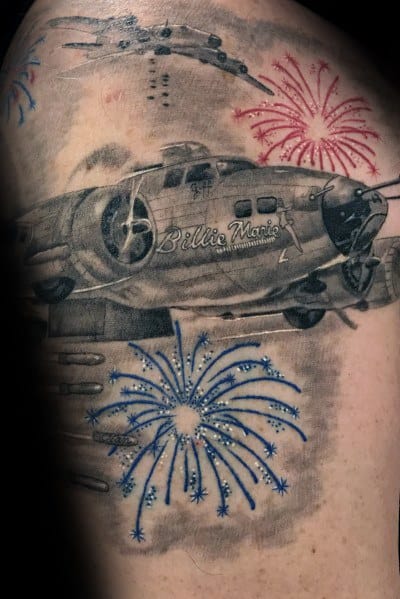 Black and grey tattoo of a vintage bomber plane named "Billie Marie," with red and blue fireworks bursting around it for a patriotic tribute.