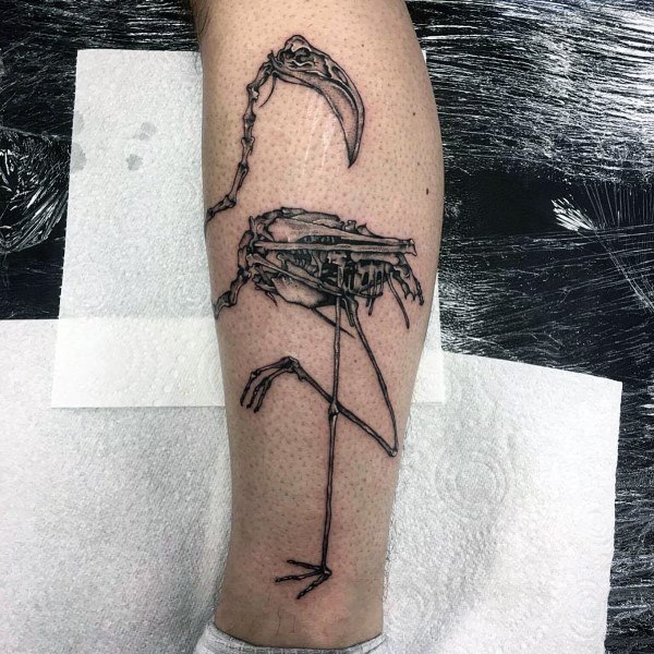 Flamingo skeleton tattoo with fine black linework and anatomical detail, giving it a dark, edgy, and artistic vibe.
