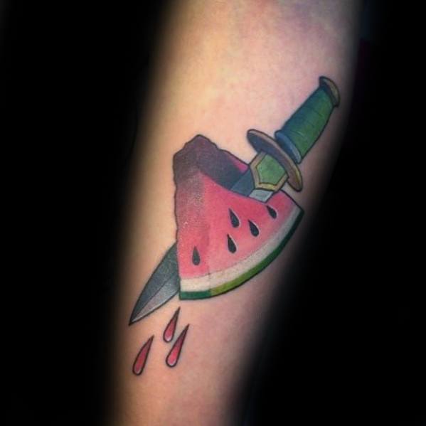 Guy With Forearm Dagger Through Watermelon Tattoo Design