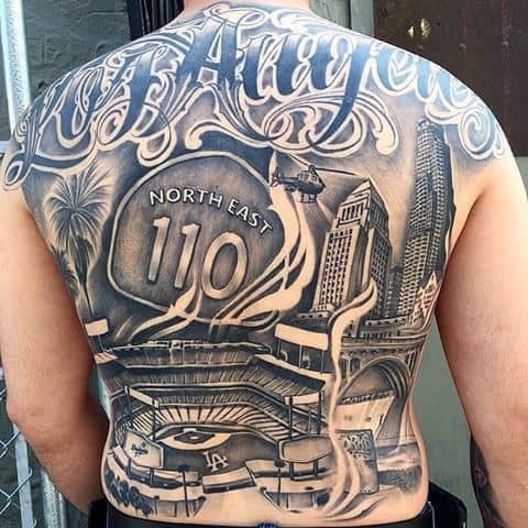 Full back tattoo showcasing Los Angeles skyline, Dodger Stadium, 110 freeway sign, helicopter, and "Los Angeles" in bold script.