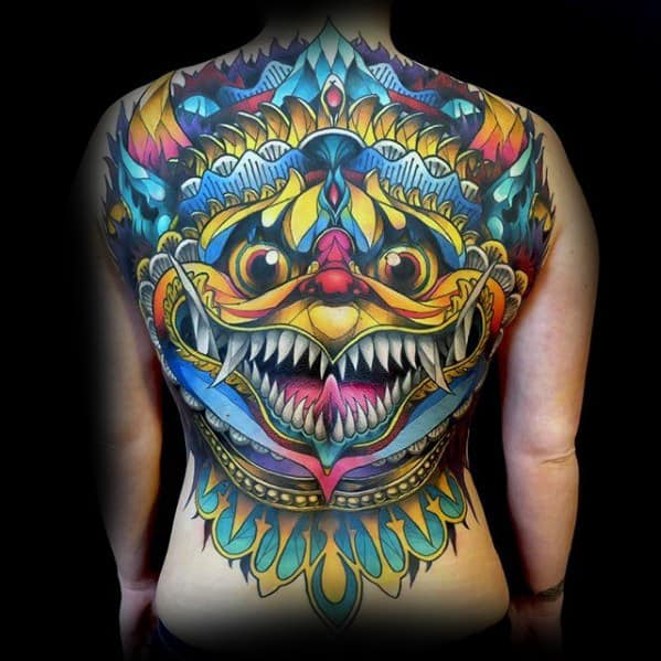 Full back Garuda tattoo in bold, vivid colors with a fierce face, sharp teeth, and elaborate symmetrical patterns and flame-like details.