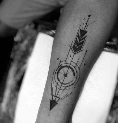 Abstract geometric arrow tattoo with bold shading, concentric circles, fine lines, and dynamic motion elements on the forearm.