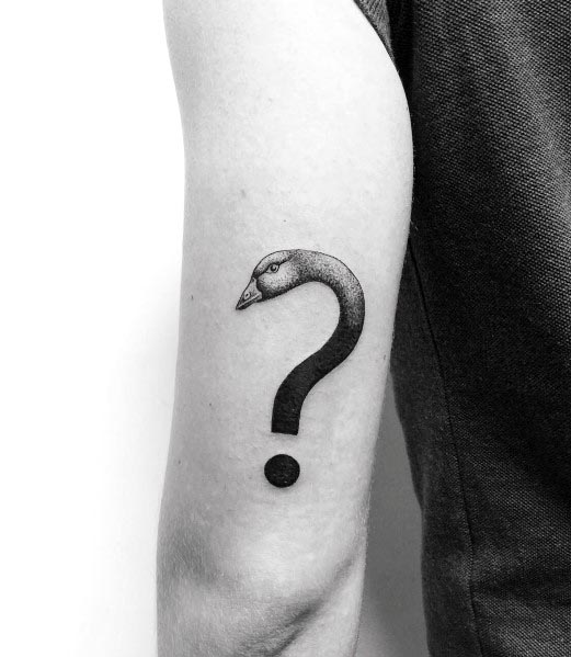 Minimalist black and gray tattoo of a goose's head seamlessly forming a question mark, inked on the upper arm with fine shading.