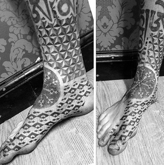 Close-up of feet and ankles with tribal-style tattoos