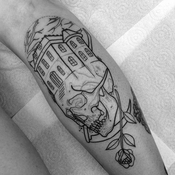 Linework tattoo of a haunted house merging with a skull, full moon, flying bats, bare trees, and a single rose below the jaw.