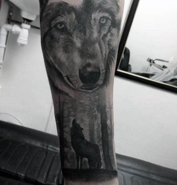 Guy With Howling Wolf Silhouette Forest Tattoo On Forearms