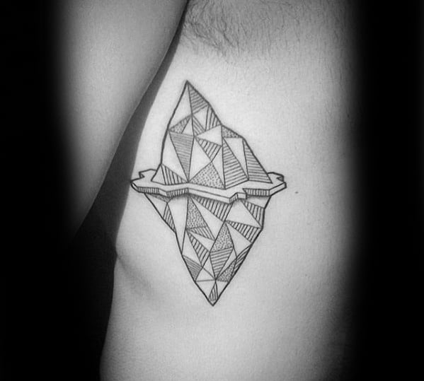Geometric iceberg tattoo on the ribs, filled with intricate patterns and bold lines above and below the waterline.