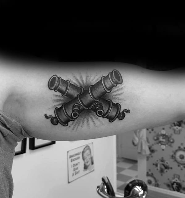 Guy With Inner Arm Bicep Cannon Tattoo Design