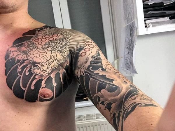 Guy With Japanese Foo Dog Chest And Half Sleeve Tattoo