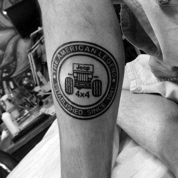 Black and grey circular Jeep tattoo featuring "The American Legend" text, a classic Jeep illustration, and "Established Since 1941" banner.