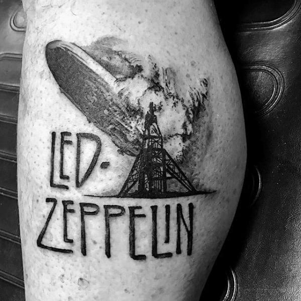 Black and gray tattoo of the Zeppelin airship explosion above bold Led Zeppelin lettering, capturing the iconic imagery from their debut album.
