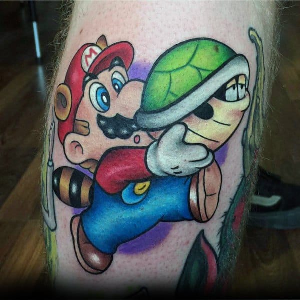 Bold and colorful *Super Mario* tattoo featuring Mario in his Tanooki suit, dynamically holding a Koopa shell with detailed shading and vibrant tones.