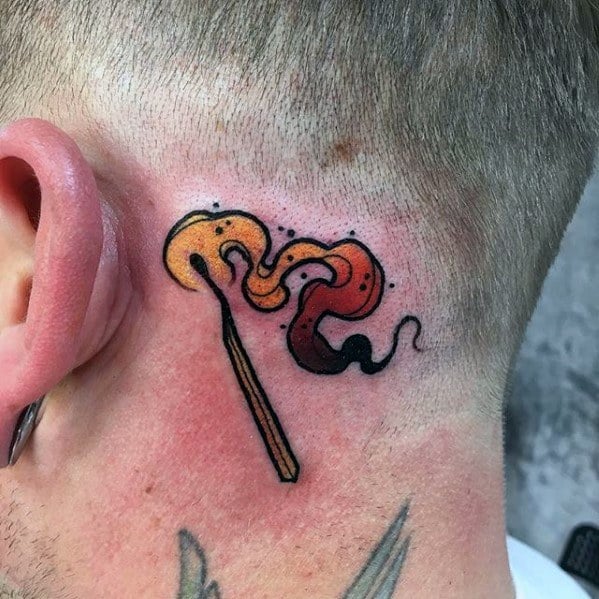 Colorful matchstick tattoo behind the ear with vibrant orange and red smoke, symbolizing bold ideas, rebellion, or a hidden inner spark.