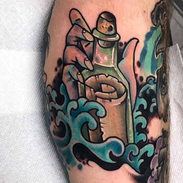 Tattoo of a hand gripping a bottle with a message amid swirling ocean waves