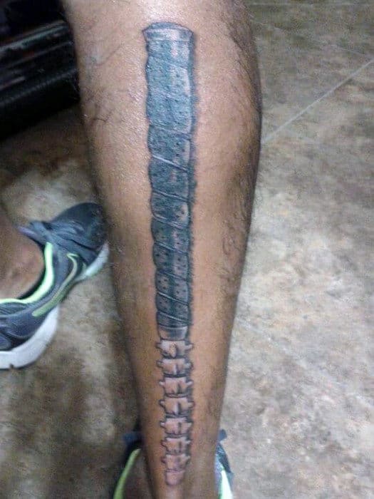 Guy With Metallic Golf Club Tattoo On Calves