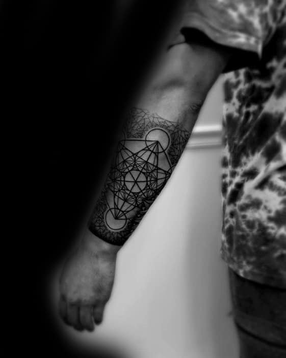 Minimalist Metatron’s Cube tattoo on the forearm with clean black lines and subtle dotwork forming a sacred geometry pattern.