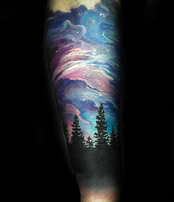 Guy With Northern Lights Black Tree Tattoo On Forearm