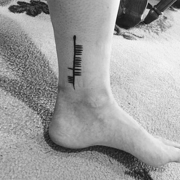 Guy With Ogham Tattoo Design Lower Leg