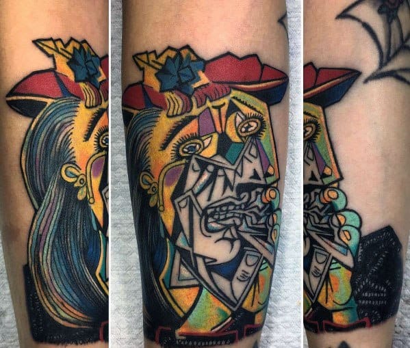 Vibrant tattoo of Picasso’s *Weeping Woman*, showcasing intense emotion with bold colors, sharp cubist lines, and expressive detail.