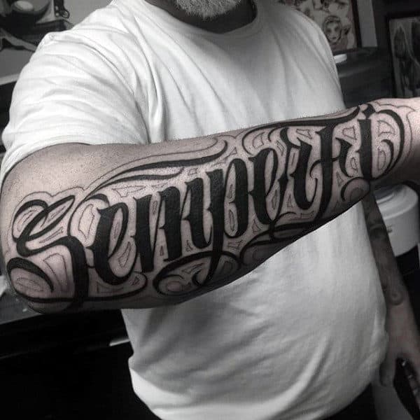 Guy With Pitch Black Lettering Tattoo Forearms