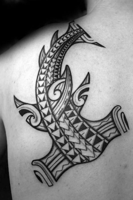 Polynesian hammerhead shark tattoo on upper back with bold tribal details symbolizing strength, warrior spirit, and ocean protection.