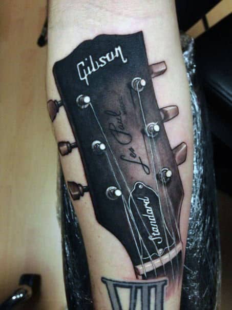 Guy With Realistic Guitar Head Tattoo On Arms