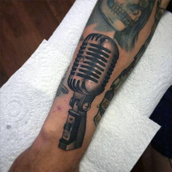 Guy With Rusty Microphone Tattoo On Forearms