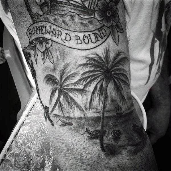 Guy With Scenic Palm Tree Tattoo On Arms