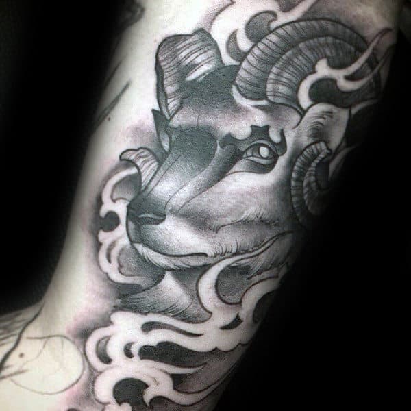 Guy With Shaded Black And Grey Ink Ram Arm Tattoos