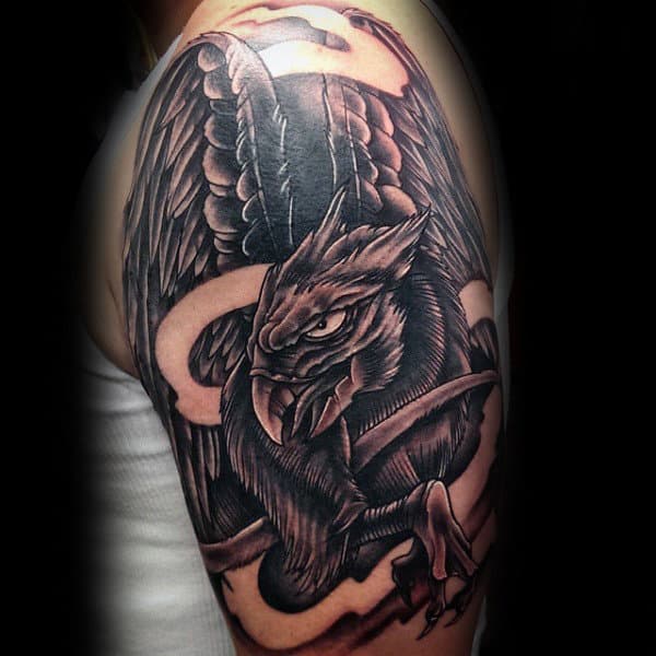 Guy With Shaded Dark Griffin Arm Tattoo